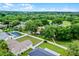 Expansive backyard with a white fence, perfect for outdoor activities, surrounded by lush greenery and neighborhood views at 15916 Indian Wells Ct, Clermont, FL 34711