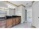 Bathroom with double sinks, granite countertop, decorative border, and plenty of cabinet space at 15916 Indian Wells Ct, Clermont, FL 34711
