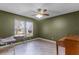 Bedroom with neutral wall and tile flooring, featuring a large window with vertical blinds at 15916 Indian Wells Ct, Clermont, FL 34711