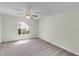 Bright bedroom featuring neutral-colored walls, plush carpeting, and a sunlit window with outdoor views at 15916 Indian Wells Ct, Clermont, FL 34711
