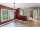 Inviting dining room with colorful accent wall, tile flooring, and stylish chandelier fixture at 15916 Indian Wells Ct, Clermont, FL 34711