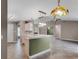 Open concept kitchen with breakfast bar island, tiled floors, and views into the living room at 15916 Indian Wells Ct, Clermont, FL 34711