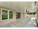 Spacious covered lanai, perfect for entertaining with ceiling fans, screened enclosure, and outdoor views at 15916 Indian Wells Ct, Clermont, FL 34711