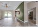 Open concept living room with tiled floors, a ceiling fan, and access to the kitchen at 15916 Indian Wells Ct, Clermont, FL 34711