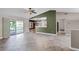 Inviting living area featuring tile flooring, sliding glass doors, and a pass-through to the kitchen at 15916 Indian Wells Ct, Clermont, FL 34711