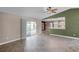 Bright living room with sliding glass doors, tile floors, and an open view to the kitchen at 15916 Indian Wells Ct, Clermont, FL 34711