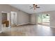 Open living room with tile floors, sliding glass doors, and access to other rooms in the home at 15916 Indian Wells Ct, Clermont, FL 34711