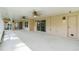 Large covered patio features ceiling fans, sliding glass doors to the interior, and a back door at 15916 Indian Wells Ct, Clermont, FL 34711