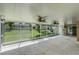Spacious screened-in patio offers a view of the grassy backyard with lush landscaping and fencing at 15916 Indian Wells Ct, Clermont, FL 34711