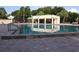 View of a rectangular community pool with well-maintained paving and a 6 ft depth marker at 15916 Indian Wells Ct, Clermont, FL 34711