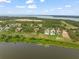 Waterfront community aerial showcasing picturesque homes and the tranquil lake setting at 16320 Pendio Dr, Bella Collina, FL 34756