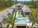 Luxury home aerial view with an inviting pool, spa, and seamless indoor-outdoor entertaining spaces at 16320 Pendio Dr, Bella Collina, FL 34756