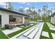 Spacious backyard featuring an outdoor kitchen, inviting seating, a pool, and a home theater screen at 16320 Pendio Dr, Bella Collina, FL 34756