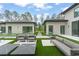 Expansive backyard featuring modern architecture, seating areas, and meticulously maintained greenery at 16320 Pendio Dr, Bella Collina, FL 34756