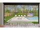 A striking view of a backyard patio featuring a sunken lounge, pool, landscaping and outdoor TV at 16320 Pendio Dr, Bella Collina, FL 34756