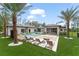 A spacious backyard patio with a pool, sunken lounge, and lush landscaping is perfect for outdoor entertaining at 16320 Pendio Dr, Bella Collina, FL 34756