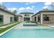An inviting backyard pool features a built-in hot tub and manicured landscaping for luxurious outdoor living at 16320 Pendio Dr, Bella Collina, FL 34756