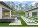 Outdoor living space featuring comfortable seating, an outdoor kitchen, and a pool with a theater screen at 16320 Pendio Dr, Bella Collina, FL 34756