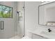 Modern bathroom featuring a glass enclosed shower with a gray tiled accent wall at 16320 Pendio Dr, Bella Collina, FL 34756