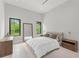 Bright bedroom featuring neutral decor, large windows with exterior views and plush carpeting at 16320 Pendio Dr, Bella Collina, FL 34756