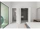 Modern bedroom boasts backyard view, walk-in closet, and ensuite bath in a neutral color palette at 16320 Pendio Dr, Bella Collina, FL 34756