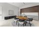 Modern dining area with seating, kitchen, and decorative wall art with lots of natural light at 16320 Pendio Dr, Bella Collina, FL 34756