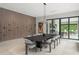 Elegant dining room with modern lighting and wall-mounted wine rack, perfect for entertaining at 16320 Pendio Dr, Bella Collina, FL 34756