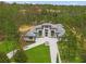 Stately home exterior showcasing a modern design, lush landscaping, and a long driveway leading up to the impressive entrance at 16320 Pendio Dr, Bella Collina, FL 34756