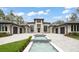 Elegant modern home with striking water feature, grand entrance and a circular driveway at 16320 Pendio Dr, Bella Collina, FL 34756