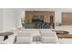 Bright living room highlighting modern sofas, stylish decor, and a glimpse of the home's kitchen and wine storage at 16320 Pendio Dr, Bella Collina, FL 34756
