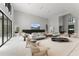 Large, airy living room featuring high ceilings, stylish seating, and a fireplace with views to outdoors at 16320 Pendio Dr, Bella Collina, FL 34756