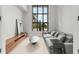 Cozy living room features a comfortable seating area, a modern entertainment center, and large windows with natural light at 16320 Pendio Dr, Bella Collina, FL 34756