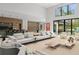 Spacious open-concept living room featuring high ceilings and floor-to-ceiling windows with natural light at 16320 Pendio Dr, Bella Collina, FL 34756