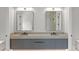 Contemporary bathroom with double sink vanity, gray cabinets, and large mirrors at 16320 Pendio Dr, Bella Collina, FL 34756