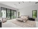 Serene main bedroom with expansive windows and a comfortable seating area, and ensuite bathroom at 16320 Pendio Dr, Bella Collina, FL 34756