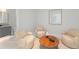 Comfortable sitting area with plush seating and a circular wood coffee table at 16320 Pendio Dr, Bella Collina, FL 34756
