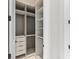 Organized walk-in closet featuring custom shelving, drawers, and hanging rods for optimal storage solutions at 16320 Pendio Dr, Bella Collina, FL 34756