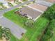 An aerial view of the home displaying a meticulously manicured lawn and screened lanai at 17461 Se 82Nd Albemarle Ave, The Villages, FL 32162