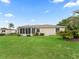 Well-maintained backyard featuring a screened-in porch and tropical landscaping at 17461 Se 82Nd Albemarle Ave, The Villages, FL 32162