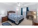Cozy bedroom with a wood frame bed, blue quilt, desk and chair, with natural light from the window at 17461 Se 82Nd Albemarle Ave, The Villages, FL 32162