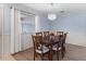 Charming dining room featuring a chandelier, wood table, and light blue walls at 17461 Se 82Nd Albemarle Ave, The Villages, FL 32162