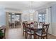 Light and bright dining room boasting wood floors and a view of the screened lanai at 17461 Se 82Nd Albemarle Ave, The Villages, FL 32162