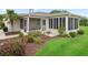 A well maintained home exterior with a screened lanai, neat landscaping, and lush green lawn at 17461 Se 82Nd Albemarle Ave, The Villages, FL 32162