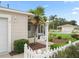 Close-up of home entrance with a landscaped yard, palm tree, and a well-lit address sign at 17461 Se 82Nd Albemarle Ave, The Villages, FL 32162