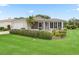 Inviting single-story home featuring an attached garage, well-kept lawn, and a screened porch with lots of sunshine at 17461 Se 82Nd Albemarle Ave, The Villages, FL 32162