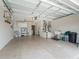 Spacious garage with high ceilings, ample storage, and a utility sink, offering practicality and organization at 17461 Se 82Nd Albemarle Ave, The Villages, FL 32162