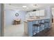 Open-concept kitchen with counter seating area and adjacent small dining space at 17461 Se 82Nd Albemarle Ave, The Villages, FL 32162