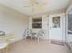 Cozy screened lanai with tile flooring, ceiling fan, and comfortable seating for relaxation at 17461 Se 82Nd Albemarle Ave, The Villages, FL 32162
