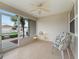 Relaxing screened lanai featuring tile flooring, ceiling fan, and a view of the well-maintained yard at 17461 Se 82Nd Albemarle Ave, The Villages, FL 32162