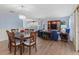 Open-concept living area featuring wood flooring, a chandelier, and plenty of natural light at 17461 Se 82Nd Albemarle Ave, The Villages, FL 32162